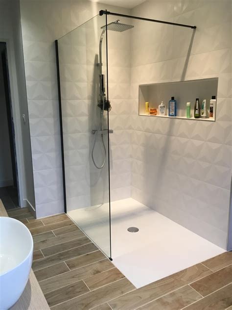 A Bathroom With A Glass Shower Door And White Sink In The Corner Next To It