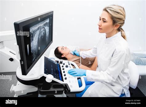 Woman Endocrinologist Making Ultrasonography To A Female Patient In An