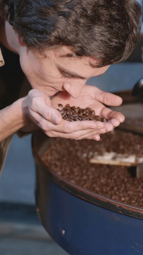 A Man Smelling the Aroma of Roasted Coffee BeansFree Stock Video
