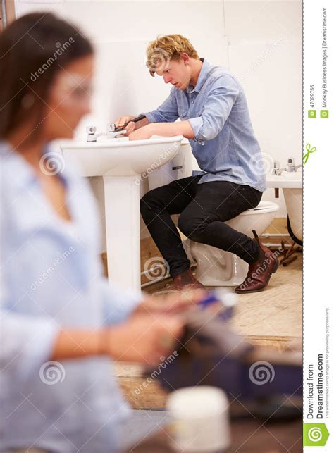 College Students Studying Plumbing Working On Washbasin Stock Photo