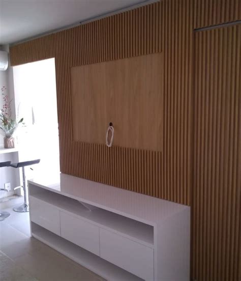 An Empty Room With Wooden Paneling On The Wall And White Furniture In