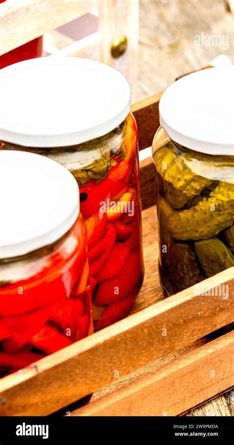 Wooden Crate With Glass Jars With Pickled Red Bell Peppers And Pickled