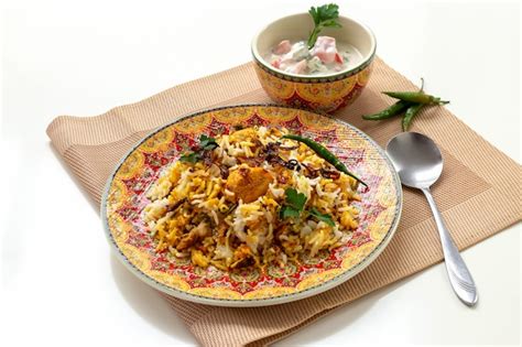 Premium Photo Halal Indian Chicken Biryani Served With Yogurt Tomato