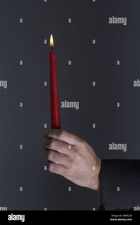 Male Man In A Suit Holding A Red Lit Candle In His Hand Stock Photo Alamy