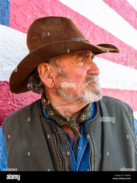 Close Up On A Old Cowboy Face With A Grizzled Gray Beard And Weathered