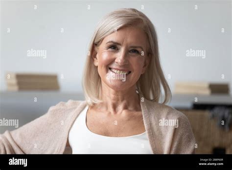 Head Shot Close Up Portrait Of Pleasant Smiling Mature Woman Stock