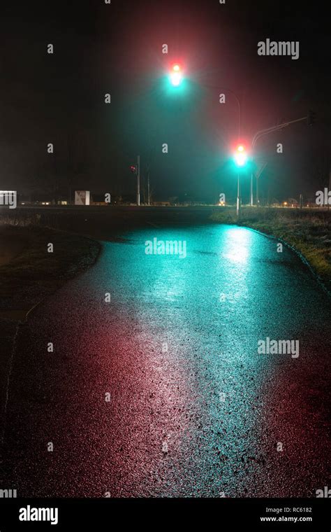 Traffic light showing red and green light in wet night Stock Photo - Alamy