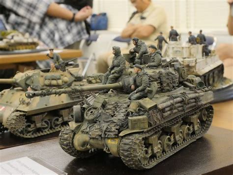 toy soldiers are sitting on top of an army tank with other toys in the ...