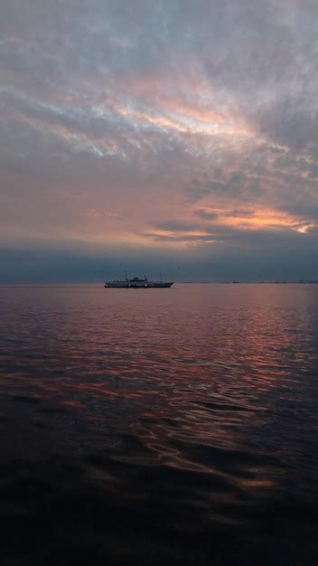 Premium Photo | A ferry at sunset