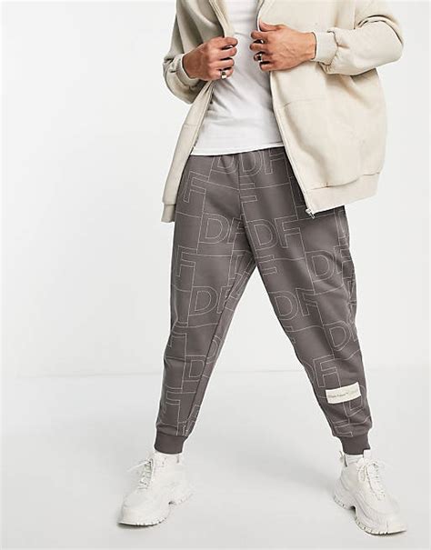 Asos Dark Future Co Ord Relaxed Joggers With All Over Logo Print In