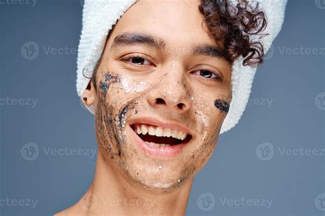 Cheerful Guy With A Towel On His Head Cosmetics On The Face Clean Skin