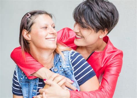 Premium Photo Smiling Lesbian Couple Embracing Against White Background