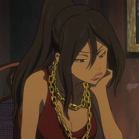 A Woman With Long Black Hair Wearing A Red Top And Gold Chain Around