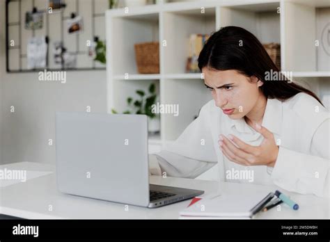 Angry Young Woman At Home Office Desk Work Online On Computer Have