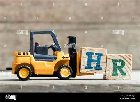 Toy Yellow Forklift Hold Letter Block H To Complete Word Hr