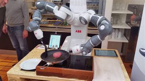 Robot Cook Flipping Over Hamburger Beef Using Two Arms And Spatulas