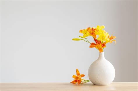 Premium Photo Summer Flowers In White Modern Vase On Wooden Shelf