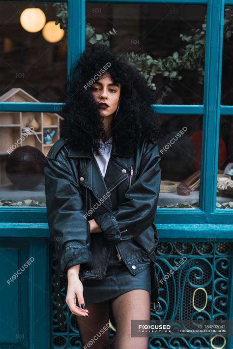 Pretty Curly Brunette Woman Standing At Case On City Street Fashion Hairstyle Stock Photo
