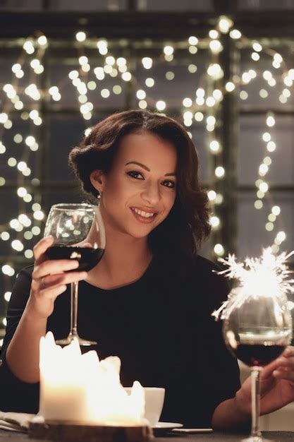 Free Photo Woman In Restaurant Holding A Wine Glass