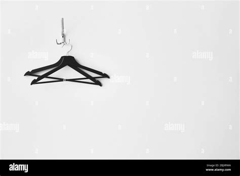 Clothes Hangers On White Wall Stock Photo Alamy