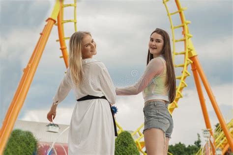 Two Caucasian Teenage Girls Enjoy at Theme Park a Roller Coaster on ...