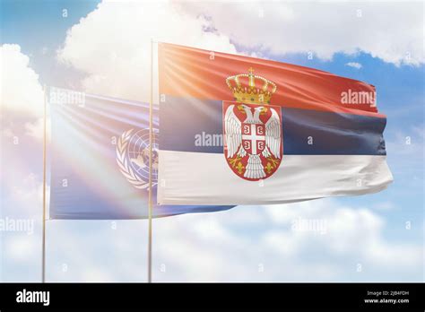 Sunny Blue Sky And Flags Of Serbia And United Nations Stock Photo Alamy