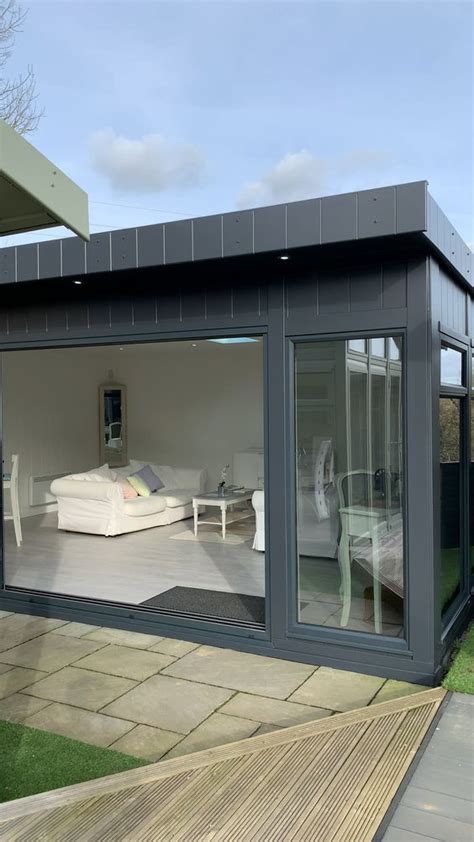 An Outdoor Room With Sliding Glass Doors On The Outside And A Bed In