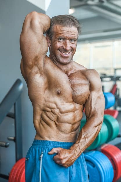 Premium Photo Brutal Aged Strong Bodybuilder Athletic Men Pumping Up