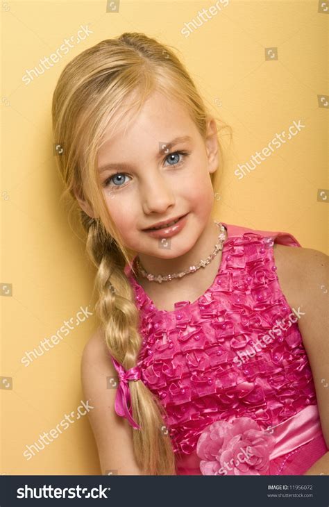 Beautiful Blond Five Year Old Girl In A Pink Dress Yellow Background