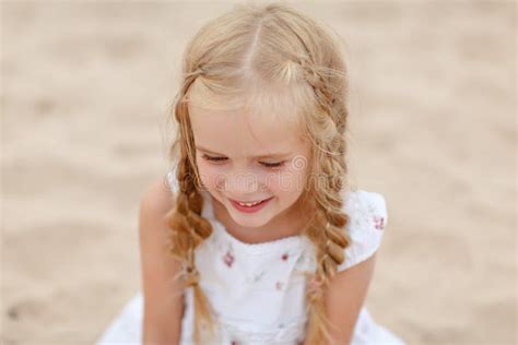 Portrait Risible Blonde Girl With Pigtails And Blue Round Eyes Stock