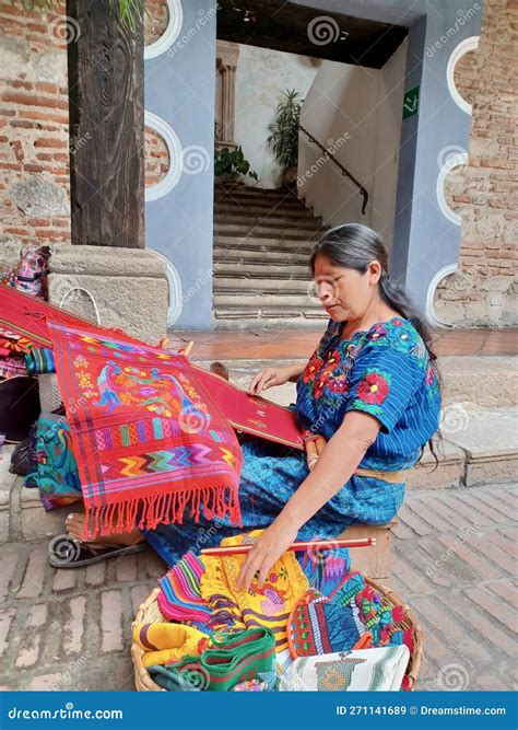 Cheerful Mayan Indian Woman Wearing A Traditional Huipil Crafting