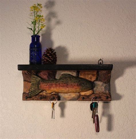 There Is A Fish On The Wall With Keys Hanging From It S Hooks