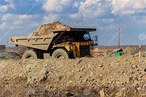 Huge Yellow Mining Dump Truck Working In Iron Ore Quarry Mining