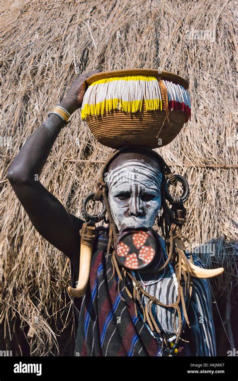 Mursi tribe people in traditional clothing with lip plate, Mursi ...