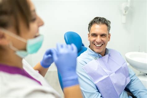 Premium Photo Dentist And Patient Interacting And Smiling