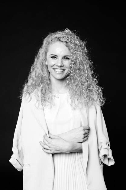 Premium Photo Portrait Of Smiling Woman With Curly Hair Standing