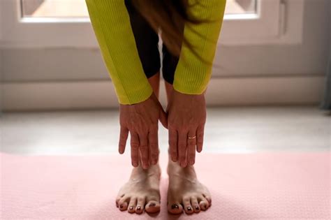 Premium Photo Crop Anonymous Female Warming Up On Mat Before Yoga