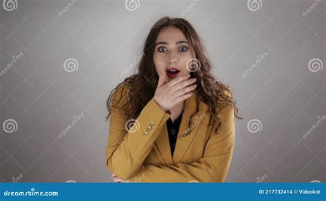 Isolated Portrait Of Woman Shocked By Some News Who Is Closing Her