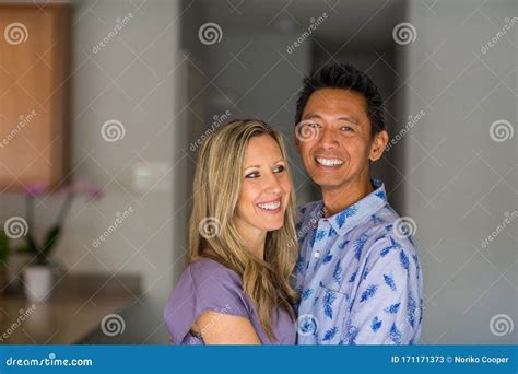 Portrait Of A Mixed Race Couple Smiling And Hugging Stock Image