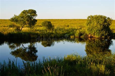 Summer Landscape With A River And Blue Sky A Small Pond In The Middle