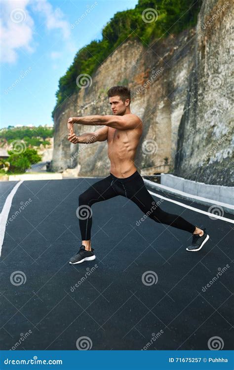 Fitness Man Stretching Body Exercising Before Running Outdoor Stock