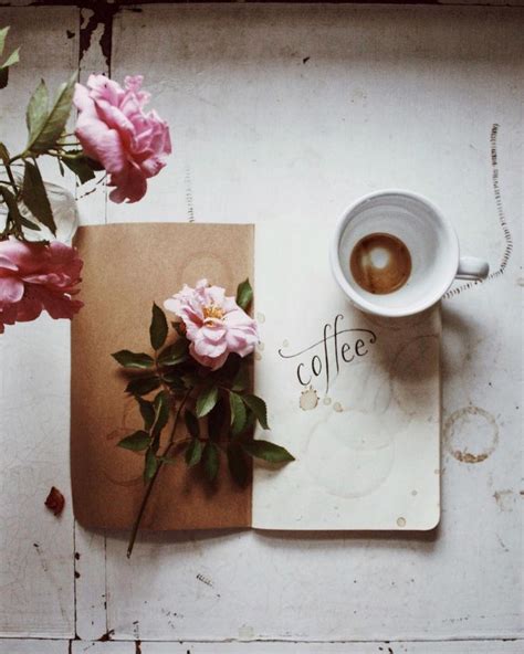 A Cup Of Coffee And Some Pink Flowers