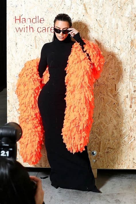 Kim Kardashian Accessorizes With A Bright Orange Feather Boa At