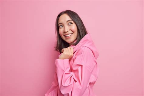 Free Photo Pretty Glad Brunette Asian Woman Stands Half Turned