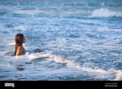 Cheerful Wet Dark Haired Girl With Wet Hair In A Bright Leopard Bikini