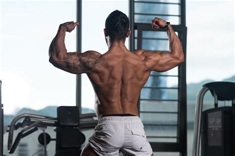 Premium Photo Muscular Man Flexing Back Muscles Pose