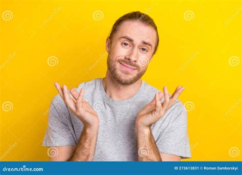 Photo Of Friendly Confused Handsome Man With Long Hairstyle Wear Gray T Shirt Hold Palms Has No