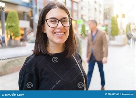 Beautiful Young Brunette Woman Smiling Excited Walking Down The City Streets Happy And