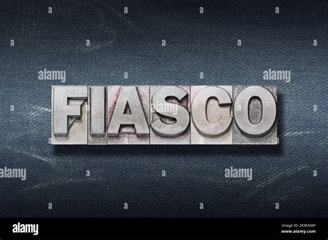 Fiasco Word Made From Metallic Letterpress On Dark Jeans Background