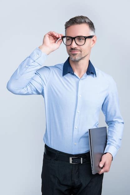 Premium Photo Mature Grizzle Man In Eyeglasses Hold Pc On Grey Background